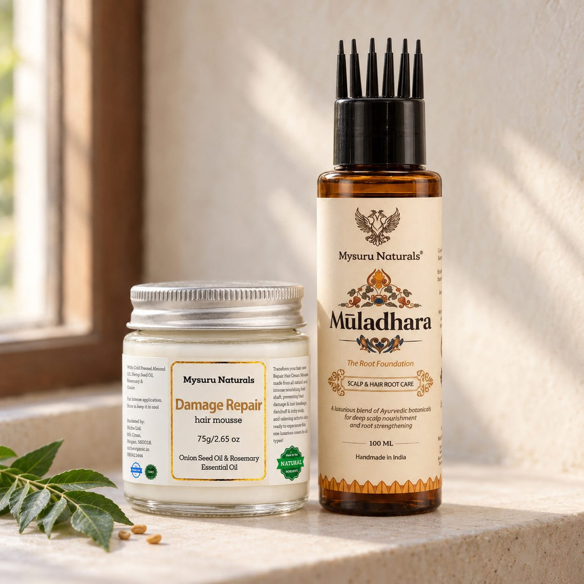 Damage Repair Prewash Cream jar and Muladhara Champi Oil bottle on a window sill