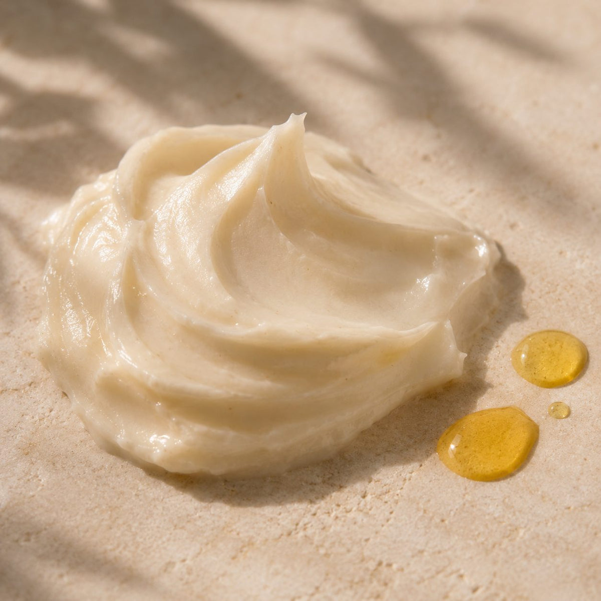 Close-up of Damage Repair Prewash Cream texture with drops of oil